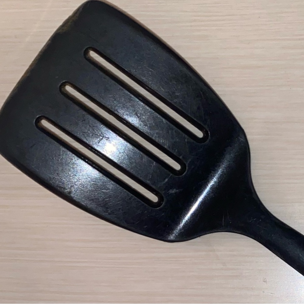 Black Tupperware slotted spatula